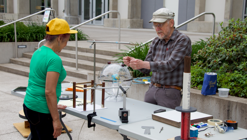 a science instructor demontrating an experiment at an event