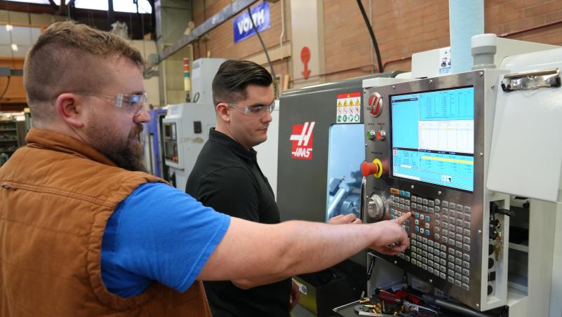 Instructor demonstrates machinery in CNC Lab at Lane Community College
