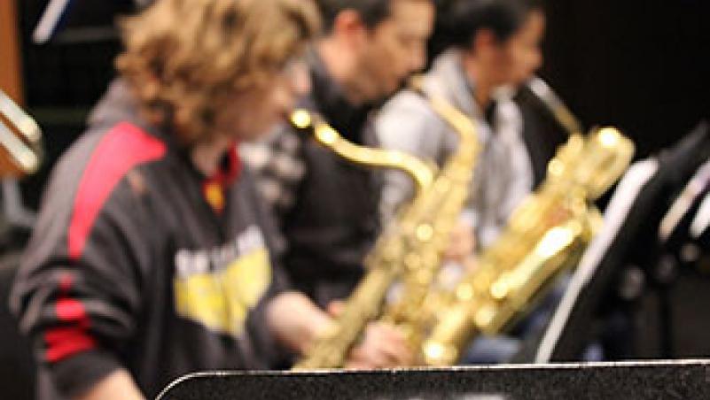 image of three students playing saxophone