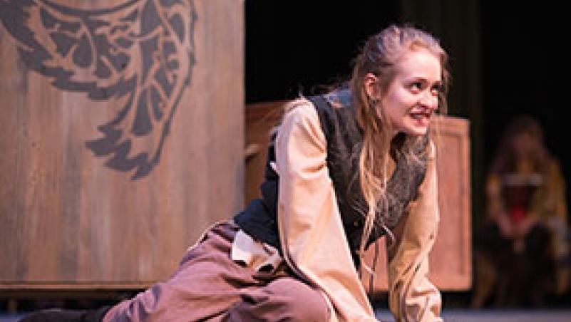 image of student actor Lydia Reynolds, sitting on stage