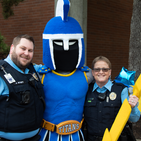 public safety officers posting with ty the titan mascot