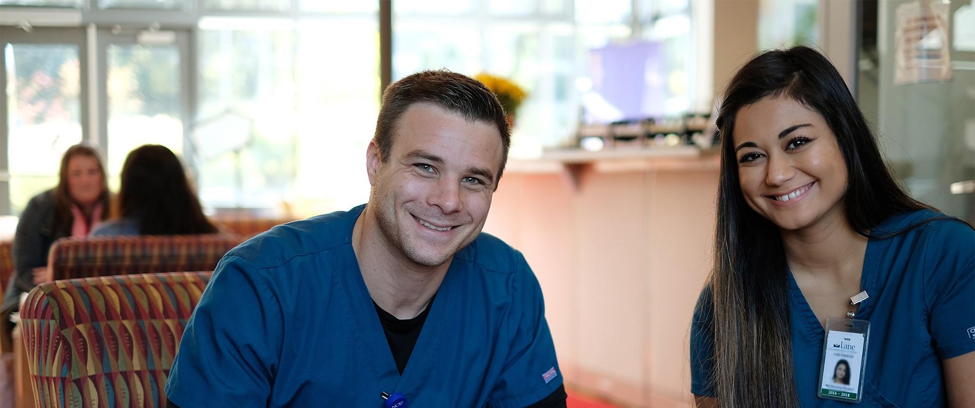 two medical professionals smiling 