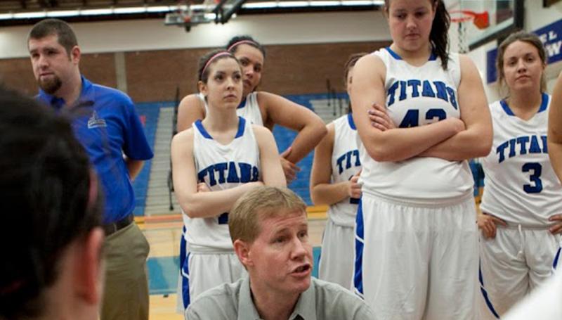 The Lane TItans Women's Basketball Team in a huddle during a game