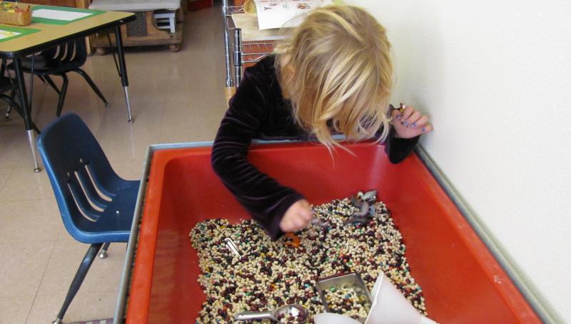 child playing with sensory toys
