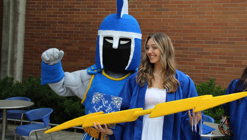 ty the titan with a graduating student holding a lightning bolt