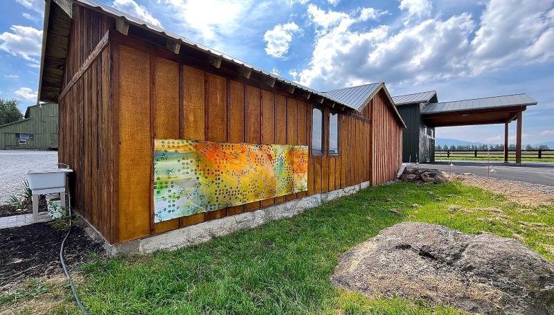 a wooden barn on a sunny day with an art mural on the side, copyright Kathleen Caprario