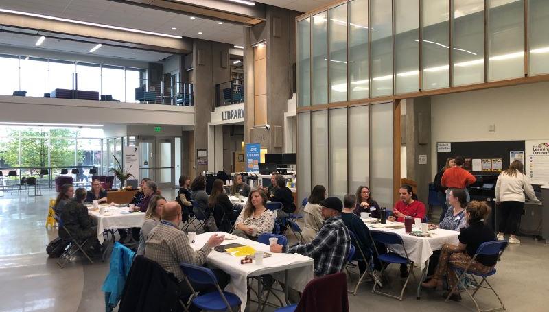LCC staff, faculty, and students at a tea party in the Center Building to discuss Common Reads