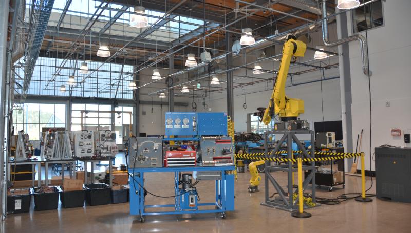 CNC workspace showing robotic arm and controller hardware