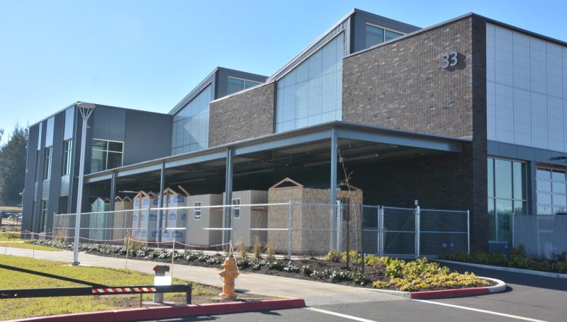 Western exterior of ITEC Building including completed tiny homes
