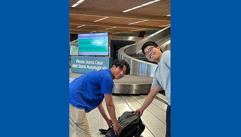 Two friendly LCC employees help an international student pick up their luggage at the Eugene Airport