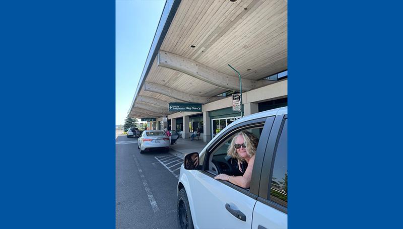 A friendly LCC employee waits in a car to pick up an arriving international student at the Eugene Airport