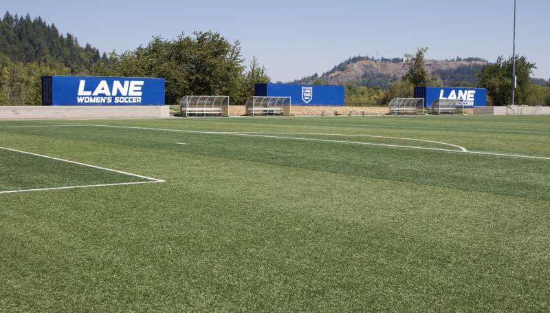 Soccer field showing women's and men's team signs