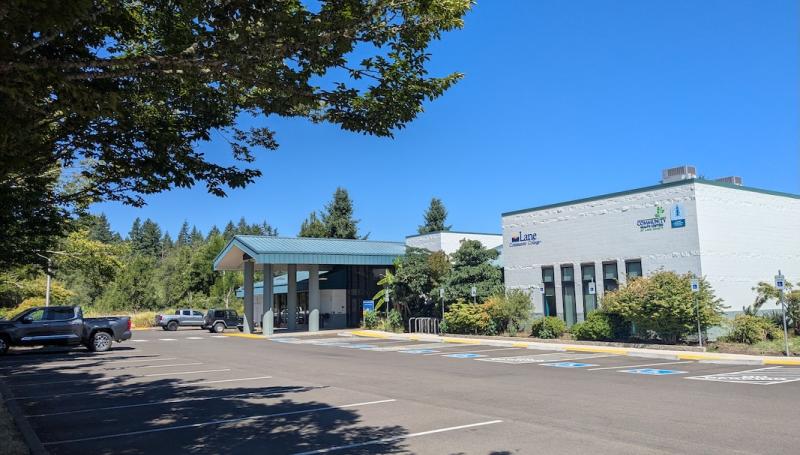 The renovated Cottage Grove Center, a welcoming building framed by trees and blue sky