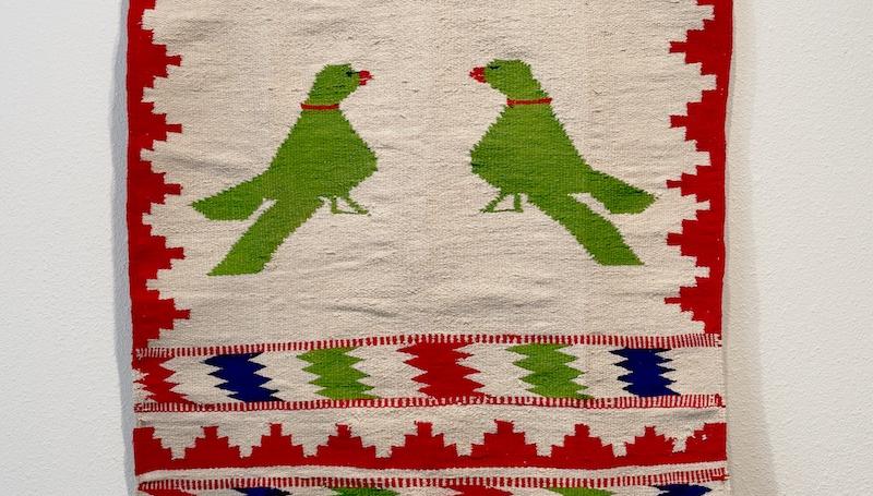 a woven textile with bright geometric patterns and birds by LCC art faculty Simranpreet Anand