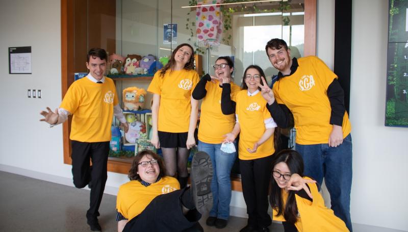 the 2026-2027 student government represenetatives wearing matching yellow shirts and posing goofily 