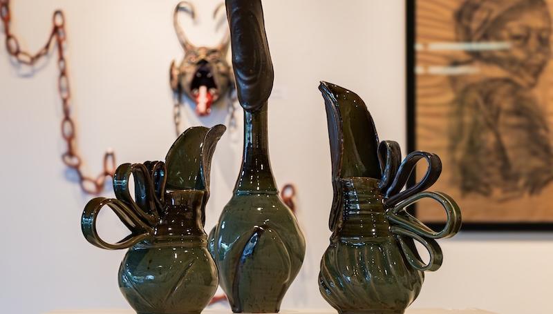 green ceramic pitchers with intricate handles by Chris Hammer