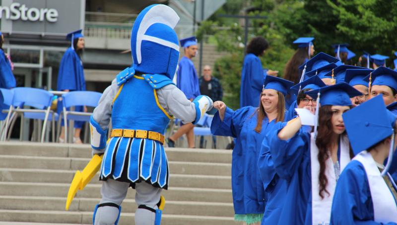 ty the titan giving a graduating student a fist bump