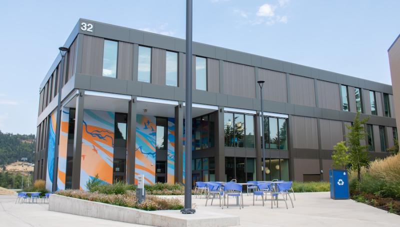 Building 32, the new health professions building, as seen from the south showcasing its mural and patio