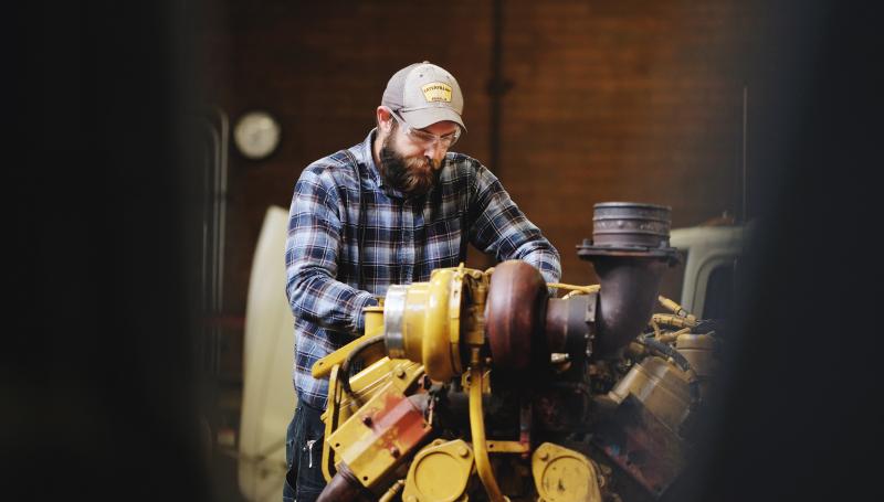 A man working on a large engine