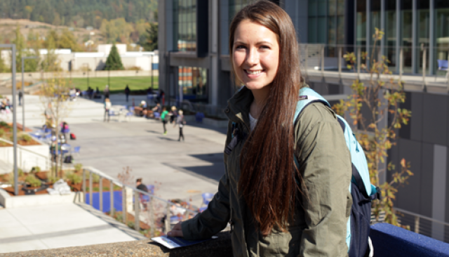 A smiling student in front of the Lane Community College campus.