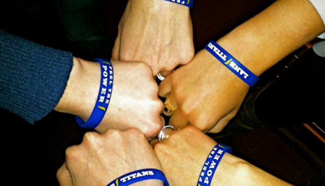 An overhead photo of the hand and wrists of five Lane Community College students.