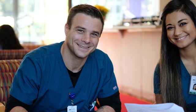 Two students in scrubs in Building 30