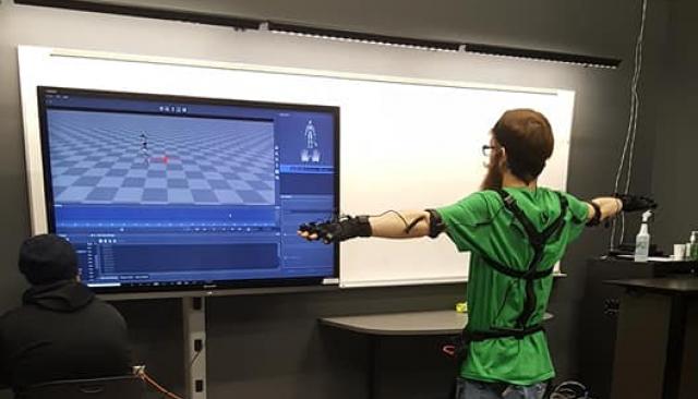 person using a program to record the movement of their body with for the use of animation