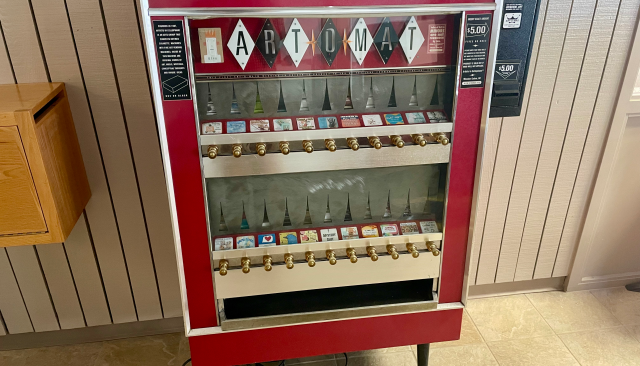 An old cigarette vending machine converted to dispense art