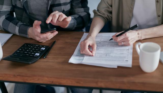 Two people working on their taxes