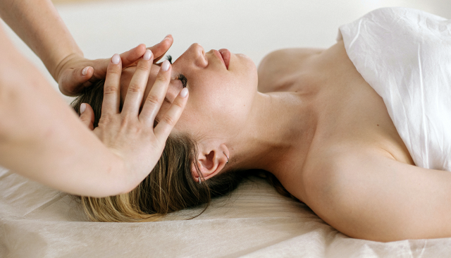 woman receiving a calming massage at a massage therapy program