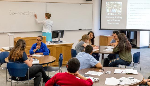 students discuss diversity and communications in a business class