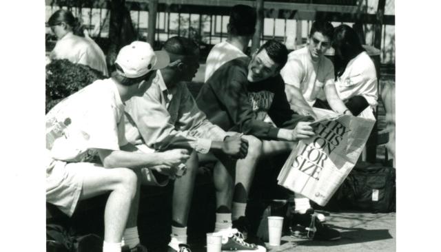 1990 photo of students with flashy sneakers hanging out on the quad