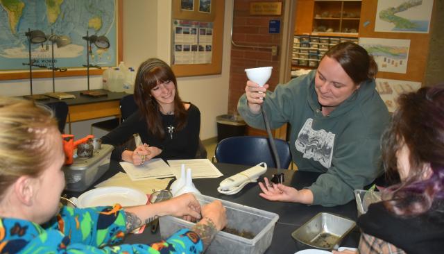 engaged students work together in a lab classroom
