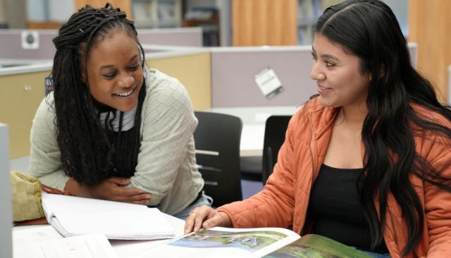 two students study together in library