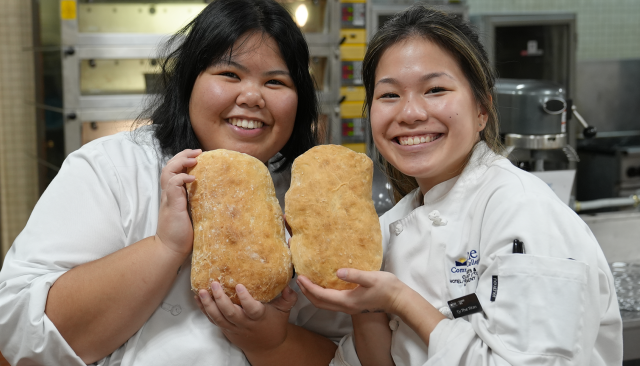 baking and culinary students smiling and showing off bread they've baked