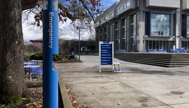 blue emergency phone in front of center building