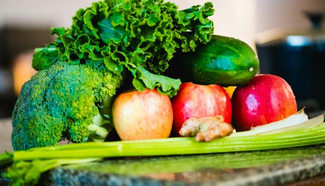 healthy food including broccoli, celery, ginger, and apples