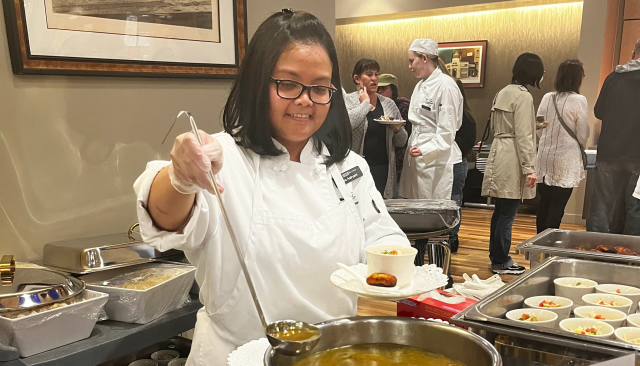 a young woman ladles soup at the Renaissance Room, LCC's restaurant