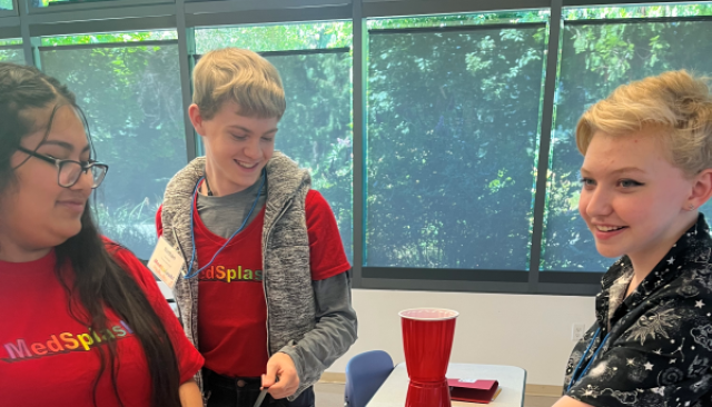 high schoolers in MedSplash shirts smiling and working together