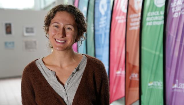 student worker smiling in building 1 