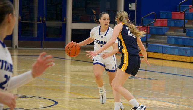 an lcc womens basketball athlete dribbles past an lbcc athlete during a game