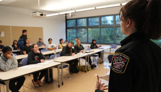A female firefighter from Pleasant Hill-Goshen fire district talks to our EMT program