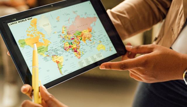 a person showing a detailed map on tablet