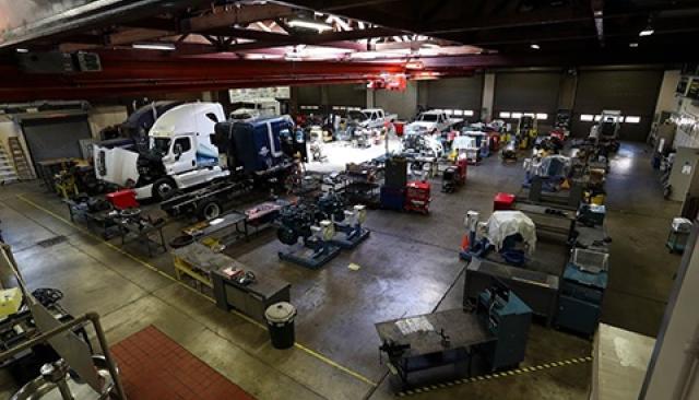 a large garage classroom on LCC campus filled with diesel trucks