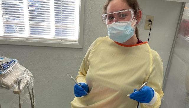 dental hygiene student practices on another student in a clinic