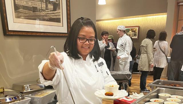 a young woman ladles soup at the Renaissance Room, LCC's restaurant