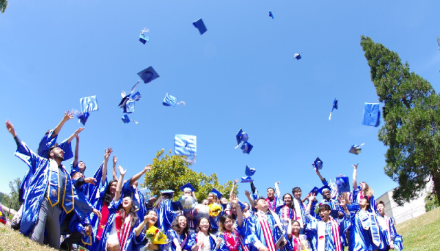 Students doing a graduation cap toss