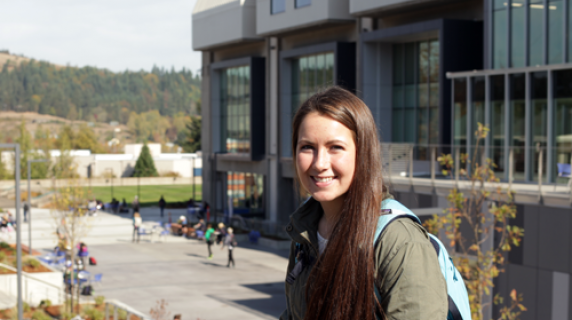 A smiling student in front of the Lane Community College campus.