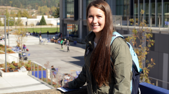 A smiling student in front of the Lane Community College campus.