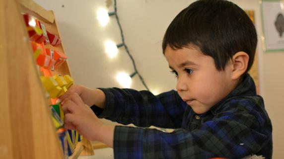 Child playing with picture blocks